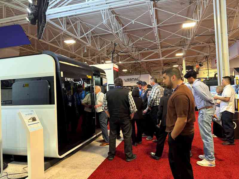 Visitors viewing the GWEIKE LF-3015GA fiber laser cutting machine at FABTECH Canada 2026